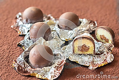 Chocolate truffles on cocoa background Stock Photo