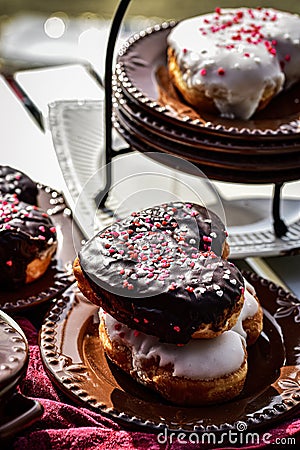 Chocolate and vanilla heart shaped donuts stacked Stock Photo