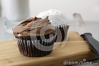 Chocolate and White Cupcakes with Glass of Milk Stock Photo