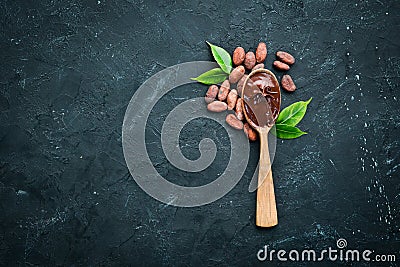 Chocolate in a wooden spoon. cocoa. Stock Photo