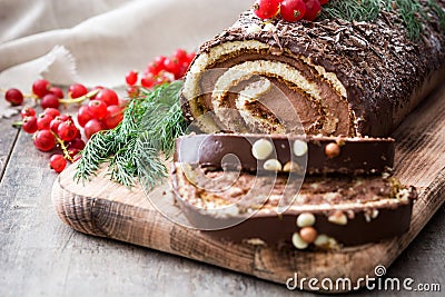 Chocolate yule log christmas cake with red currant Stock Photo
