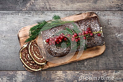 Chocolate yule log christmas cake with red currant Stock Photo