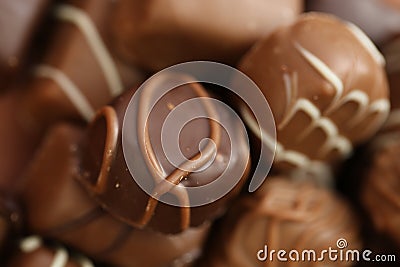 Chocolates assortment set.Chocolate sweets.Chocolate pattern. Candy on a brown background.dark milk chocolates .Set of Stock Photo