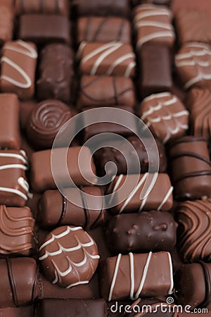 Chocolates assortment set.Chocolate sweets.Chocolate pattern. Candy close-up on a brown background.dark milk chocolates Stock Photo