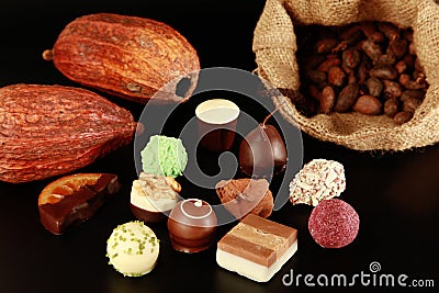 Chocolates, cocoa pods and beans Stock Photo