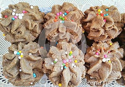 Chocolato spritzs cookies with colorful sprinkle icing sugar Stock Photo