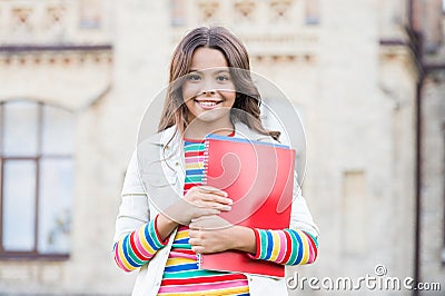 Choice course. Modern education. Kid smiling girl school student hold workbooks textbooks for studying. Education for Stock Photo