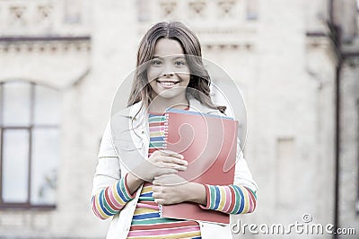 Choice course. Modern education. Kid smiling girl school student hold workbooks textbooks for studying. Education for Stock Photo