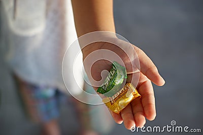 Cloes up Halls candy on liitle girl hand. Editorial Stock Photo