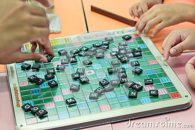 Student playing scrabble cross word Editorial Stock Photo