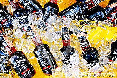 Many Cold Black whiskey mix with cola of Jack Daniel`s putting on ice in yellow tank for sale or party - Alcohol drink concept Editorial Stock Photo