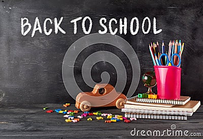 chool supplies: notebook, pencils, scissors and a wooden retro toy car Stock Photo