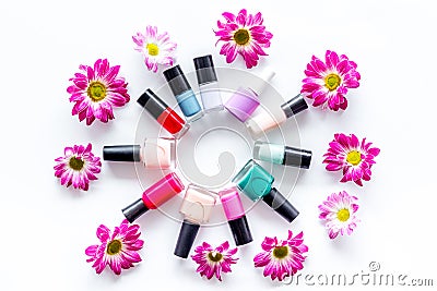 Choose nail polish for manicure. Bottles of colored polish on white background top view Stock Photo