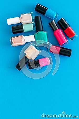 Choose nail polish. Polish bottels on blue background top view copy space Stock Photo