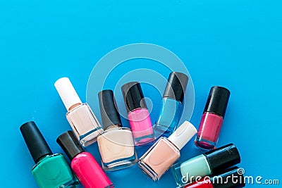 Choose nail polish. Polish bottels on blue background top view copy space Stock Photo