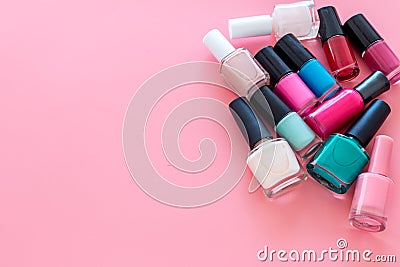 Choose nail polish. Polish bottels on pink background top view copy space Stock Photo