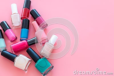 Choose nail polish. Polish bottels on pink background top view copy space Stock Photo