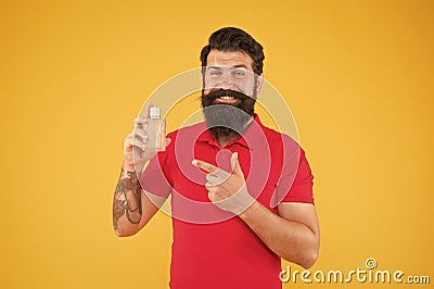 Choose pleasantly, choose us. brutal hipster choose smell. mature man presenting deodorant. fashion cologne bottle Stock Photo