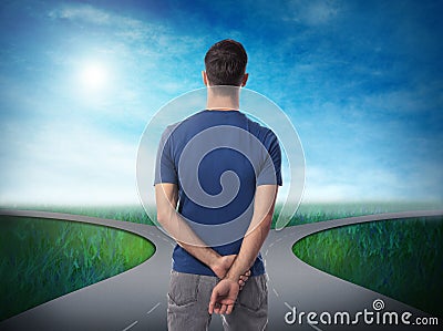 Choose your way. Man standing at crossroads taking important decision Stock Photo