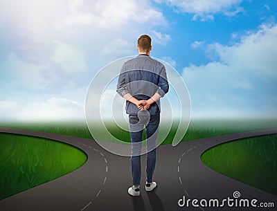 Choose your way. Man standing at crossroads taking important decision Stock Photo