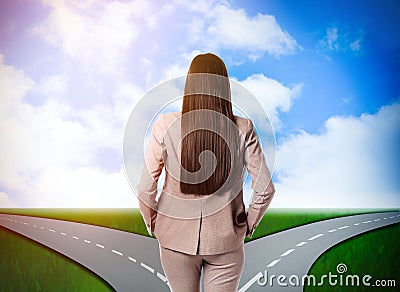 Choose your way. Woman standing at crossroads taking important decision Stock Photo