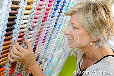 Choosing cotton at haberdashery store Stock Photo