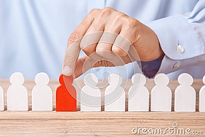 Choosing good leader worker from the crowd of bad. HR. Man in shirt takes good worker`s fingers Stock Photo