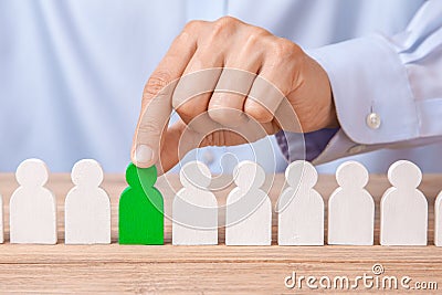 Choosing good leader worker from the crowd of bad. HR. Man in shirt takes good worker`s fingers Stock Photo