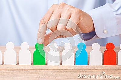 Choosing good leader worker from the crowd of bad. HR. Man in shirt takes good worker`s fingers Stock Photo