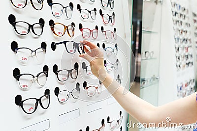 Choosing new optical glasses in optician shop Stock Photo