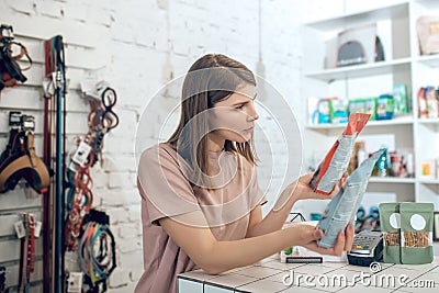 Dark-haired girl choosing nutriments for her pet in a pet store Stock Photo