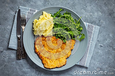 Chop pork cutlets , served with mashed potatoes and arugula. Stock Photo