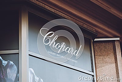 Chopard Swiss brend sign on city street. Signboard logo of Chopard Swiss manufacturer of luxury jewellery and watches store, shop Editorial Stock Photo