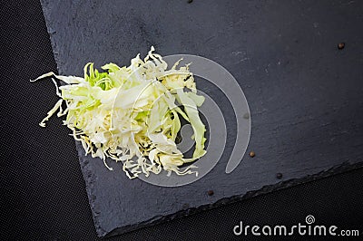 Chopped cabbage, salad ingredients on black background Stock Photo