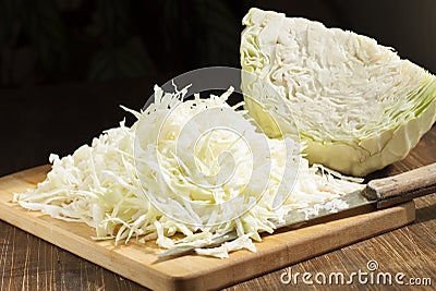 Chopped cabbage strips and a head of cabbage. Stock Photo