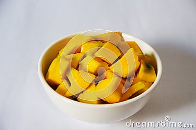 Chopped mango in white bowl Stock Photo