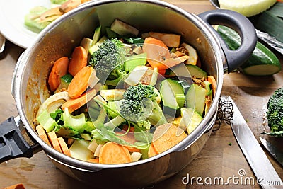 Chopped raw vegetables in pressure cooker Stock Photo