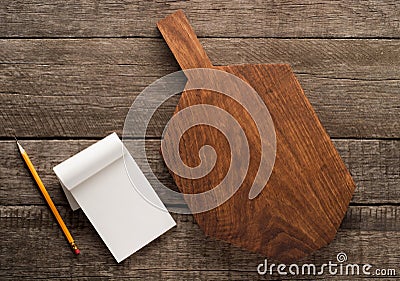 Chopping board and cookbook on wooden background Stock Photo