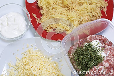 Chopping grated potatoes. Minced meat steaks with potatoes, eggs and cheese. Cooking steps and ingredients Stock Photo