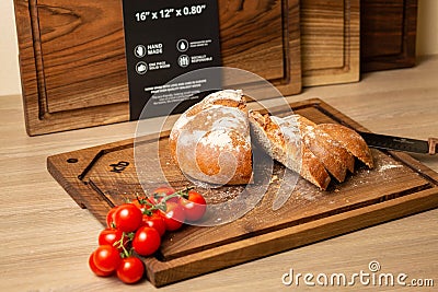 A Chopping board set with cherry tomatoes meat vegetables, fruits and cheese Editorial Stock Photo