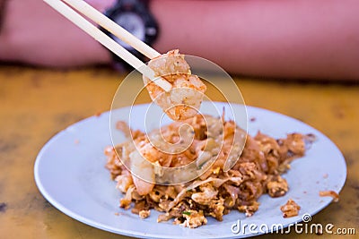 Chopstick holding big prawn from Penang Char Kuey Teow Stock Photo