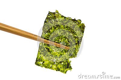 Chopsticks holding a sheet of fried seaweed on white background Stock Photo