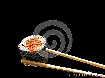 Chopsticks holding spicy salmon sushi wrap Stock Photo