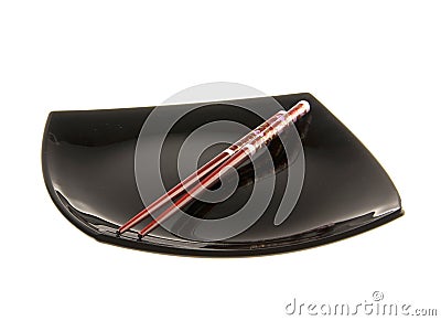 Chopsticks on a plate isolated on white Stock Photo