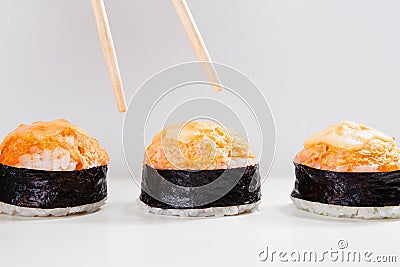 Chopsticks Reaching for Baked Salmon Gunkan Sushi Stock Photo