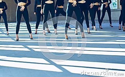 Choreography of girls dancing with black mayas and heels Stock Photo