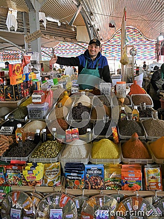 Spices vendor behind his stall in Chorsu bazaar in Tashkent, Uzbekistan Editorial Stock Photo