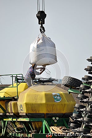 Loading bunker seeders from big bags Editorial Stock Photo