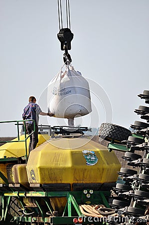 Loading bunker seeders from big bags Editorial Stock Photo