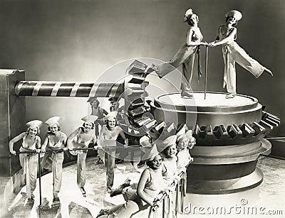 Chorus girls dancing on machine part Stock Photo